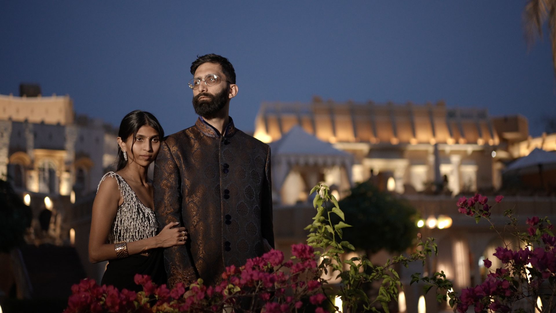 Maya and Abhishek standing together at night